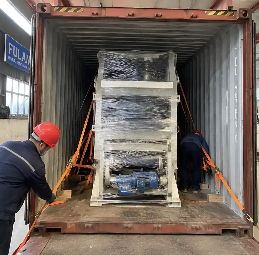 Block making machine being loaded into shipping container for Africa export