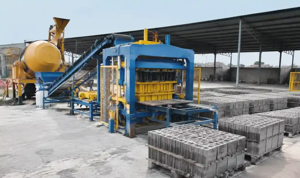 Semi-automatic block machine production line showing QT4-30 model with material hopper and control panel