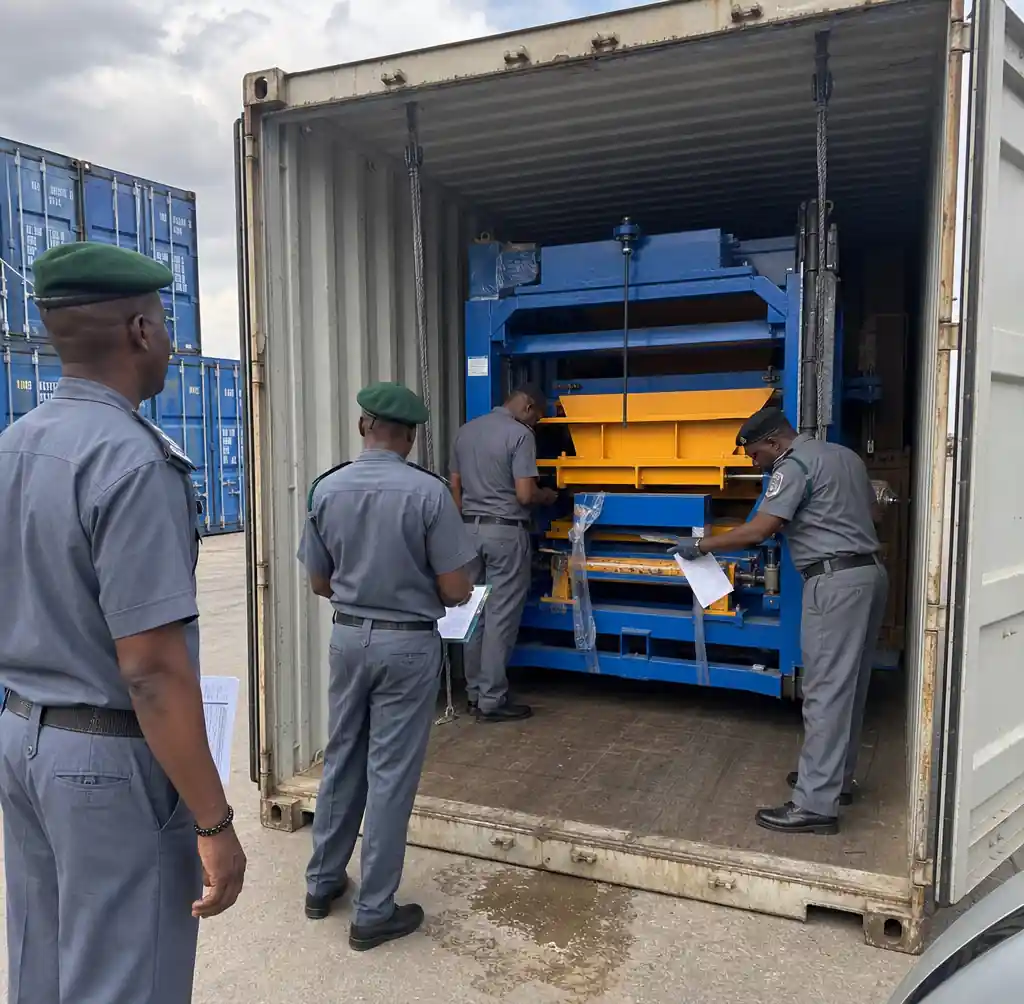 Customs officials inspecting block making machine container at African port facility