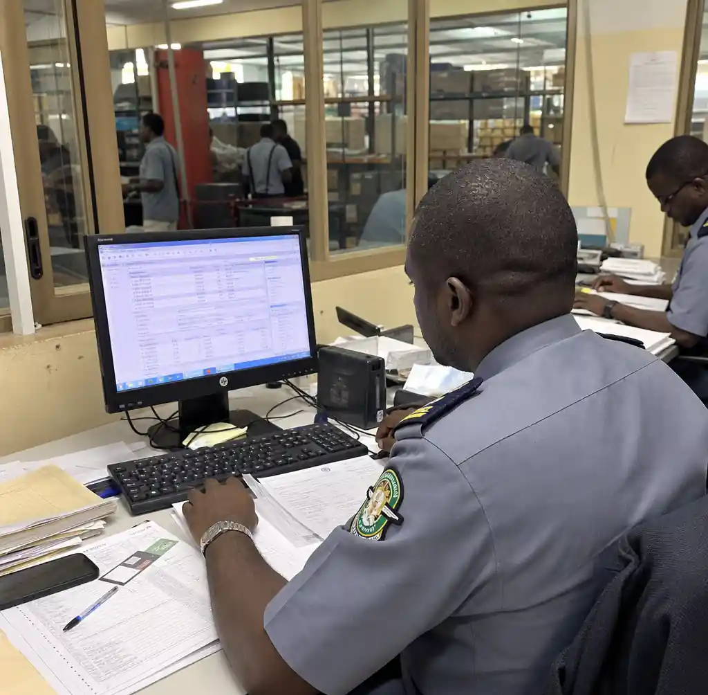 Customs broker working on clearance documents and duty payment for machinery import