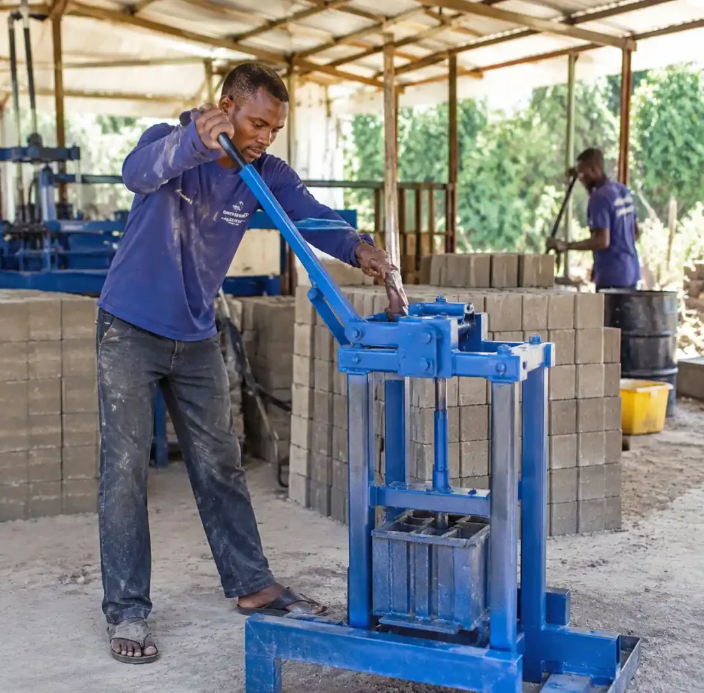 Technician performing maintenance on semi-automatic block machine